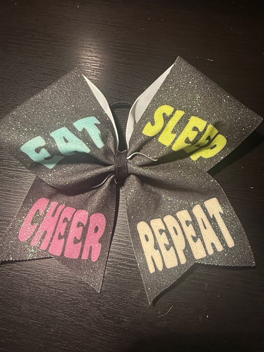 Sparkle 'Eat Sleep Cheer Repeat' Cheer Bow - Black with Multicolor Lettering